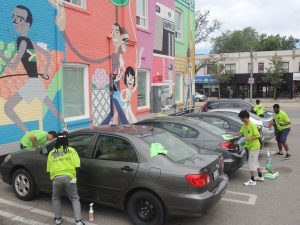 Detailers cleaning cars